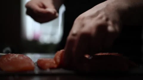 Close-Up of Hands Slicing Fresh Salmon Fillet on a Dark Background 스톡 동영상 303896067