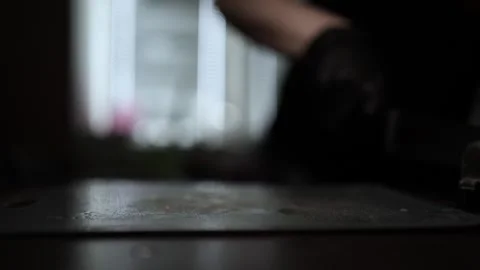 Close-Up of Hands Slicing Fresh Salmon Fillet on a Dark Background Stock Footage 303896958