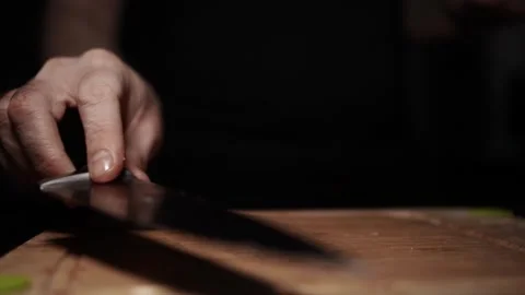 Close-Up of Hands Slicing Fresh Salmon Fillet on a Dark Background Stock-Footage 303897066