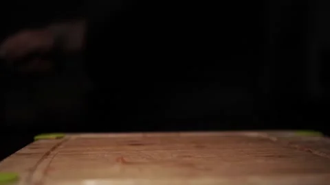 Close-Up of Hands Slicing Fresh Salmon Fillet on a Dark Background Stock-Footage 303897073