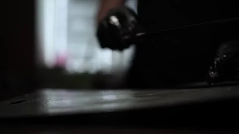 Close-Up of Hands Slicing Fresh Salmon Fillet on a Dark Background 스톡 동영상 303898925