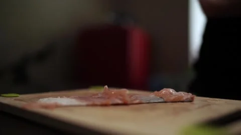 Close-Up of Hands Slicing Fresh Salmon Fillet on a Dark Background Vídeos de archivo 303898954