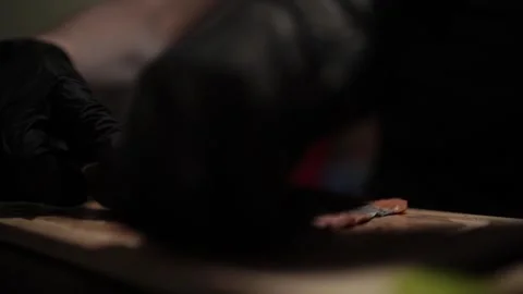 Close-Up of Hands Slicing Fresh Salmon Fillet on a Dark Background Video stock 303898971