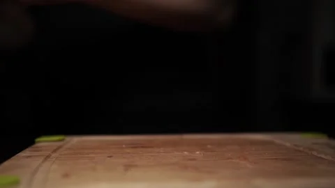 Close-Up of Hands Slicing Fresh Salmon Fillet on a Dark Background Stock Footage 303900827