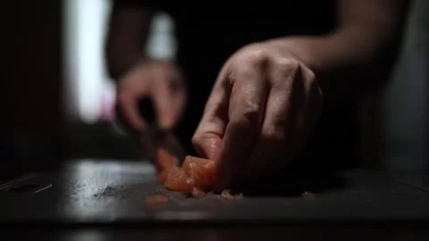 Close-Up of Hands Slicing Fresh Salmon Fillet on a Dark Background 스톡 동영상 303901616