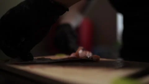 Close-Up of Hands Slicing Fresh Salmon Fillet on a Dark Background 스톡 동영상 303901693