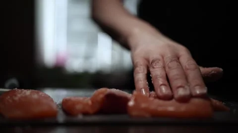 Close-Up of Hands Slicing Fresh Salmon Fillet on a Dark Background 스톡 동영상 303901970