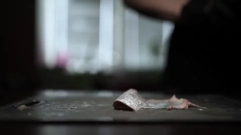 Close-Up of Hands Slicing Fresh Salmon Fillet on a Dark Background Stock-Footage 303903571