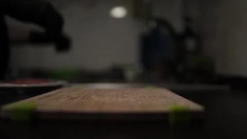 Close-Up of Hands Slicing Fresh Salmon Fillet on a Dark Background Stock Footage 303903584