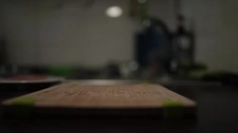 Close-Up of Hands Slicing Fresh Salmon Fillet on a Dark Background Stock Footage 303903587