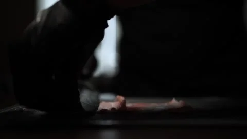 Close-Up of Hands Slicing Fresh Salmon Fillet on a Dark Background 스톡 동영상 303903744