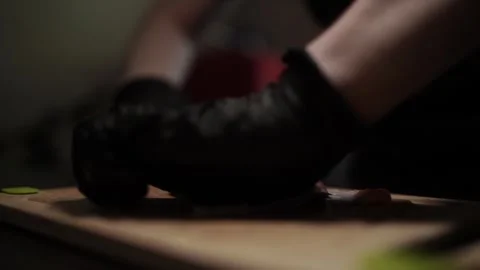 Close-Up of Hands Slicing Fresh Salmon Fillet on a Dark Background Vídeo Stock 303906367