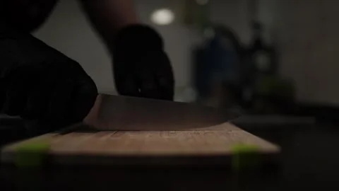Close-Up of Hands Slicing Fresh Salmon Fillet on a Dark Background Stockbeeldmateriaal 303908070