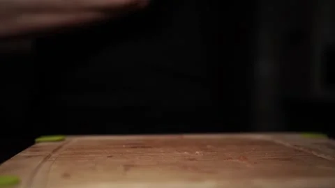 Close-Up of Hands Slicing Fresh Salmon Fillet on a Dark Background Stock-Footage 303911650