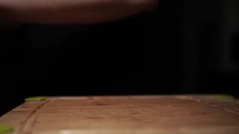 Close-Up of Hands Slicing Fresh Salmon Fillet on a Dark Background Stock Footage 303913874