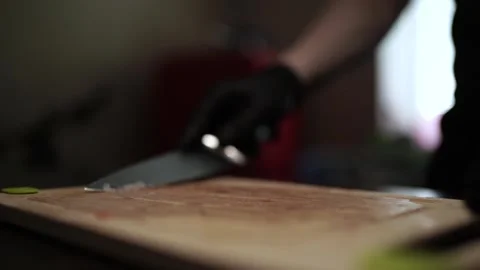 Close-Up of Hands Slicing Fresh Salmon Fillet on a Dark Background Stock Footage 303915316