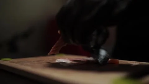 Close-Up of Hands Slicing Fresh Salmon Fillet on a Dark Background 스톡 동영상 303915737