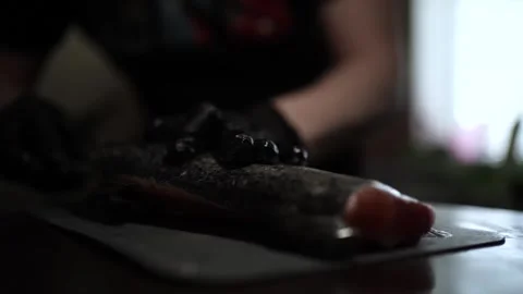 Close-Up of Hands Slicing Fresh Salmon Fillet on a Dark Background 스톡 동영상 303915858