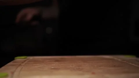 Close-Up of Hands Slicing Fresh Salmon Fillet on a Dark Background Stock-Footage 303920504