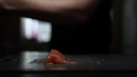 Close-Up of Hands Slicing Fresh Salmon Fillet on a Dark Background 스톡 동영상 303920931