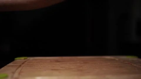 Close-Up of Hands Slicing Fresh Salmon Fillet on a Dark Background Video stock 303921376