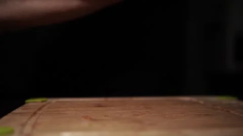 Close-Up of Hands Slicing Fresh Salmon Fillet on a Dark Background Stock Footage 303924822