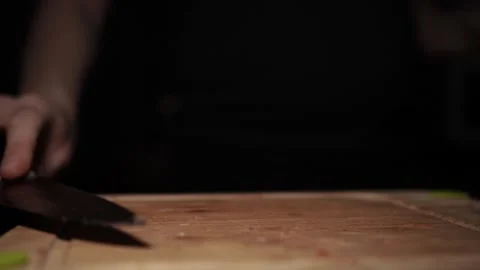 Close-Up of Hands Slicing Fresh Salmon Fillet on a Dark Background 스톡 동영상 303925868