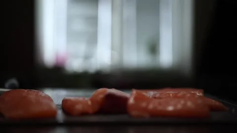 Close-Up of Hands Slicing Fresh Salmon Fillet on a Dark Background Video stock 303926174