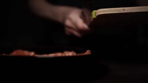 Close-Up of Hands Slicing Fresh Salmon Fillet on a Dark Background Video stock 303926211