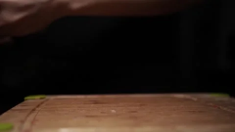 Close-Up of Hands Slicing Fresh Salmon Fillet on a Dark Background Video stock 303926219
