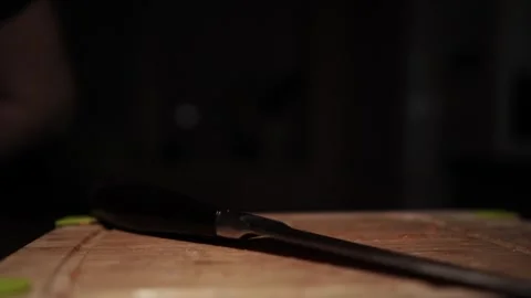 Close-Up of Hands Slicing Fresh Salmon Fillet on a Dark Background Video stock 303926261