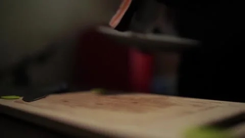 Close-Up of Hands Slicing Fresh Salmon Fillet on a Dark Background Video stock 303926375