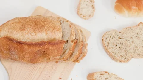 Close Up of Hands Slicing Fresh Sourdough Bread on Wooden Board Stock Footage 337535107