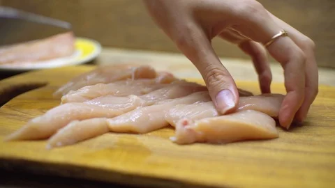Close Up Hands Slicing Raw Chicken Meat on Cutting Board 動画素材 119081377