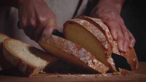 Close up of hands that slicing a traditional bread. Healthy, natural food  Stock Footage 147938732