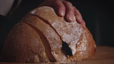 Close up of hands that slicing a traditional bread. Healthy, natural food  Stock Footage 147938787