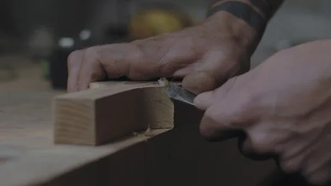 Close-up of hands slicing a wooden product with a knife. . 4k video Stock Footage 119051653