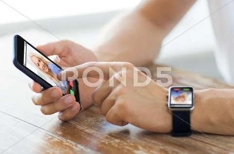 Close up of hands with smart phone and watch Stock Photos