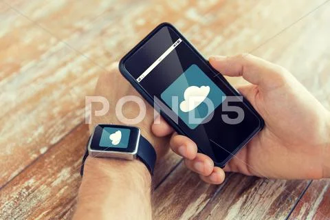 Close up of hands with smart phone and watch Stock Photos