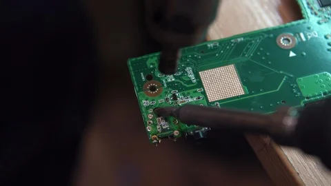 Close-up of hands soldering a computer Board. a person repairs a laptop. Stock-Footage 120059557