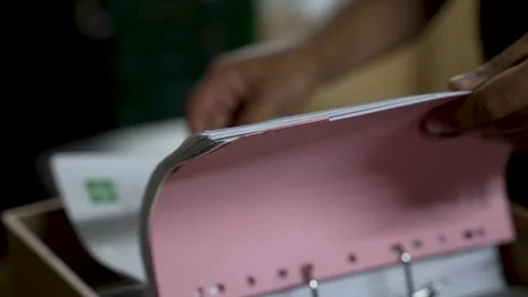 Close-up of hands sorting and organizing documents in a pink binder Video stock 278973381