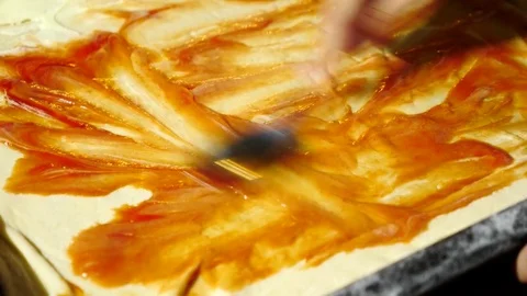 Close-up, hands spread the filling on the dough for pizza. cooking pizza, the Stock Footage 81705109