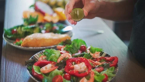Close up of Hands Squeezing Lime into Salad Slow Motion. Stock Footage 114667480