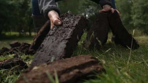 Close Up Of Hands Stacking Peat Turf Bricks To Dry For Fuel 動画素材 328698153