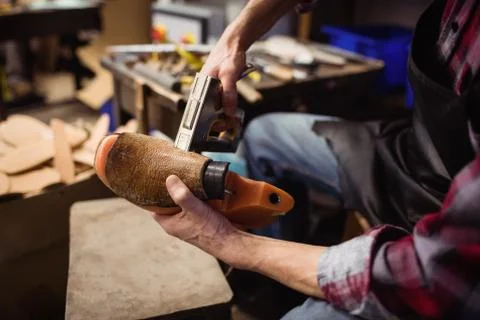 Close up of hands stapling a shoe in a workshop 写真素材