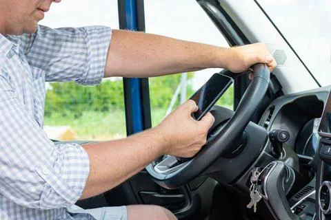 Close up of hands on steering wheel of van 写真素材