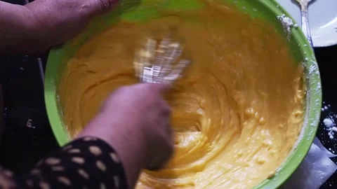 Close up of hands stirring cake batter with a whisk Stock Footage 308806428
