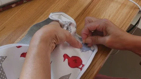 Close up of hands stitching button on arts and crafts bag Video stock 77112026