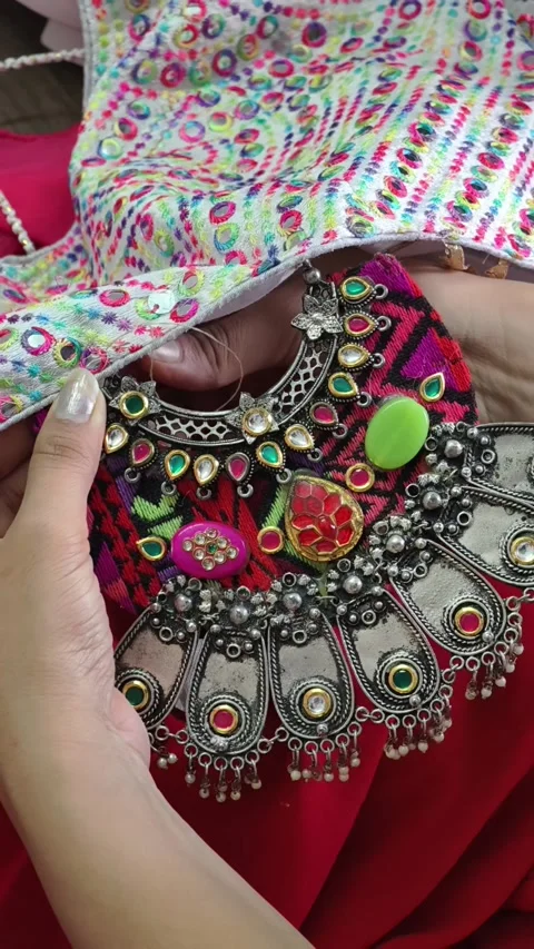 Close-up of hands stitching an ornate handcrafted embellishment onto a costume,  Stock Footage 337091471