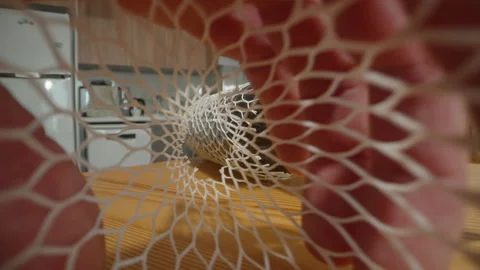 Close-Up of Hands Stretching White Mesh Sleeve over Glass Bottle with Soft Net Stock Footage 306503693